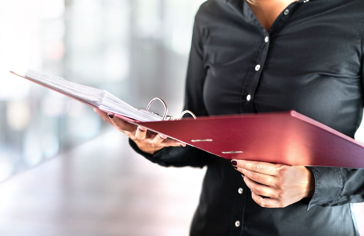 Winmark franchisee looking over a report in a binder